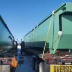 two bridge crane girders needing to be Shrink-Wrapped before heading any further down the highway. We had the opportunity to lend a helping hand to get them recovered--due to time constraints we tarped them--and on their way to Grand Coulee, WA, where they would be installed in the hydro facility there. The girders are manufactured by G&G Steel of Russellville, AL and were delivered to BCI Construction USA, Inc. at the US Bureau of Reclamation, Grand Coulee, WA, site.