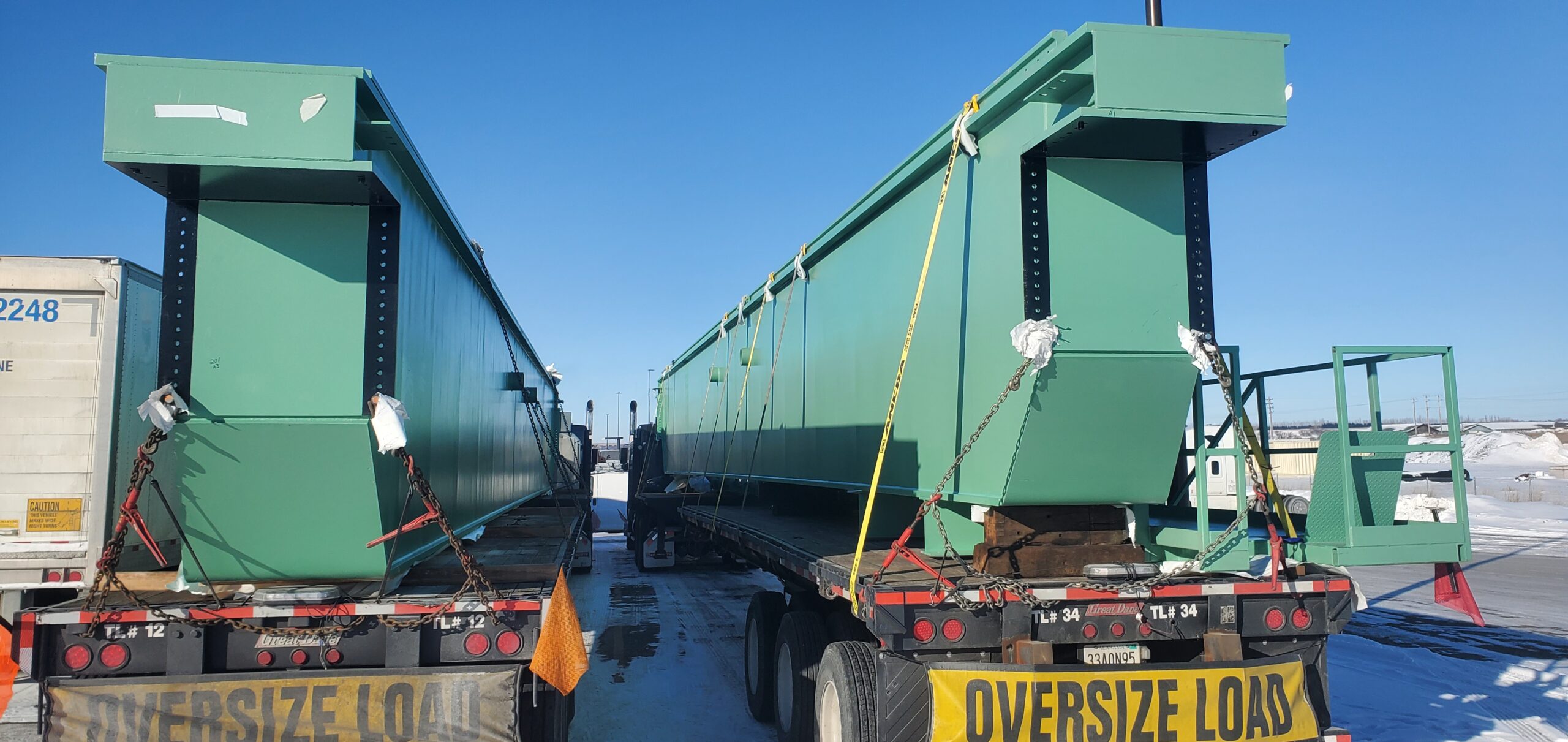 two bridge crane girders needing to be Shrink-Wrapped before heading any further down the highway. We had the opportunity to lend a helping hand to get them recovered--due to time constraints we tarped them--and on their way to Grand Coulee, WA, where they would be installed in the hydro facility there. The girders are manufactured by G&G Steel of Russellville, AL and were delivered to BCI Construction USA, Inc. at the US Bureau of Reclamation, Grand Coulee, WA, site.